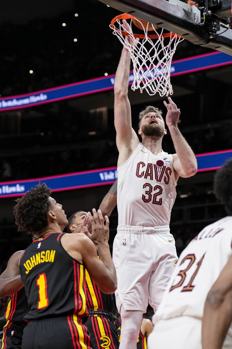 Jan 20, 2024; Atlanta, Georgia, USA; Cleveland Cavaliers forward Dean Wade (32) scores a basket over Atlanta Hawks forward Jalen Johnson (1) during the first half at State Farm Arena.